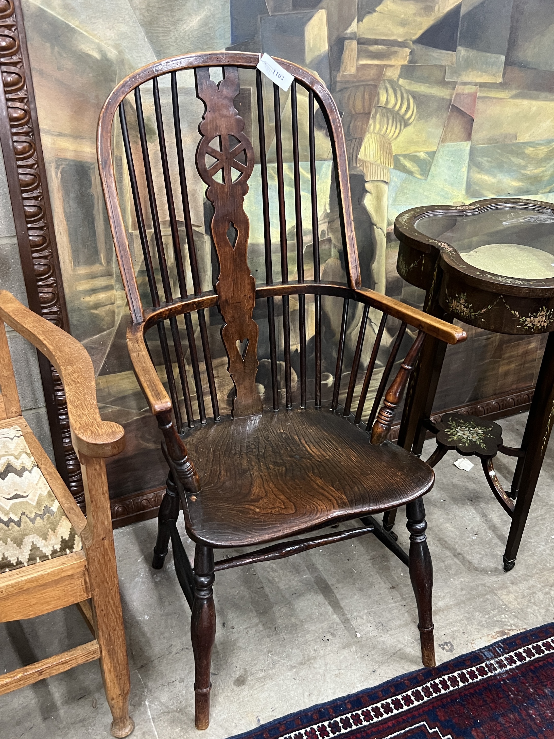 A mid 19th century Windsor elm and beech comb back armchair with pierced central splat, width 58cm, depth 42cm, height 111cm